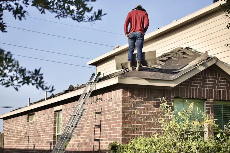 Professional roofer working on a residential roof in Four Points